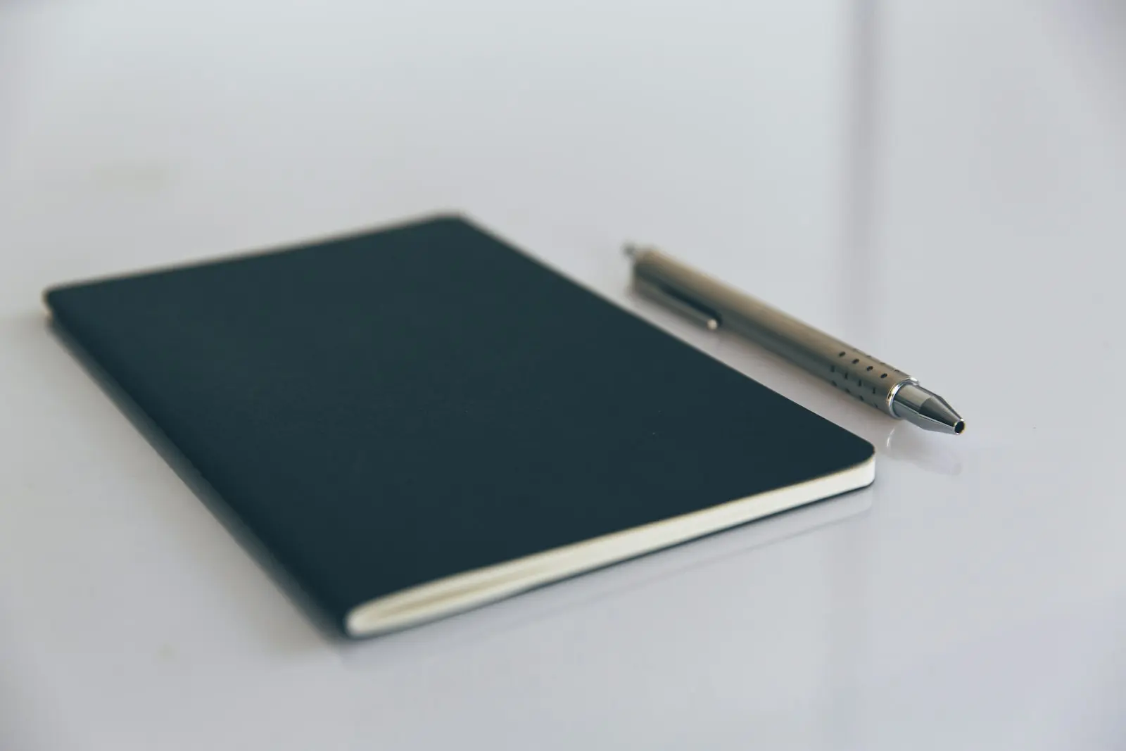 A notebook and pen on a clean desk, ready for planning work