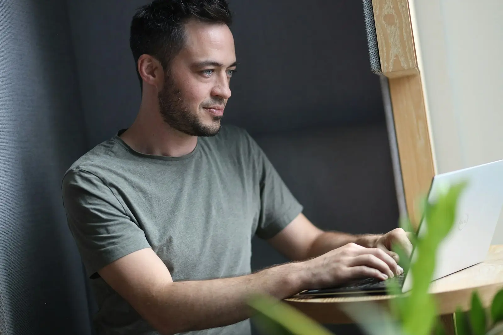A founder working at a laptop by the window